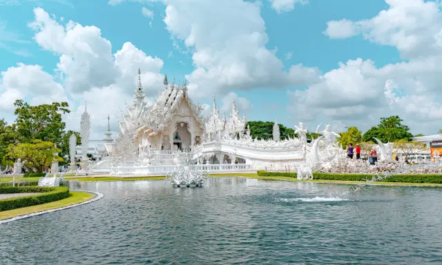 Wat Rong Khun White Temple reflected in water