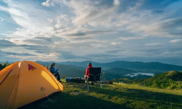 Camp at sunrise overlooking mountain valleys